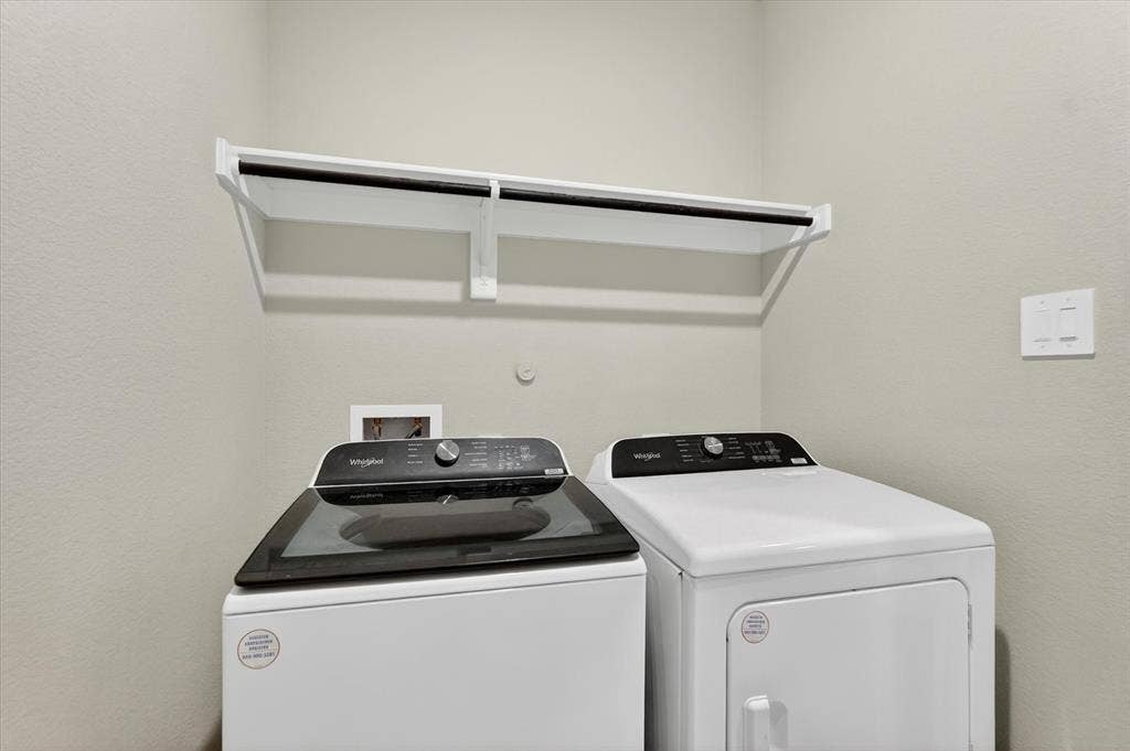 903 Edgehurst Drive, Princeton, TX 75071 Dedicated laundry area featuring a white wall-mounted shelf with an integrated hanging rod
