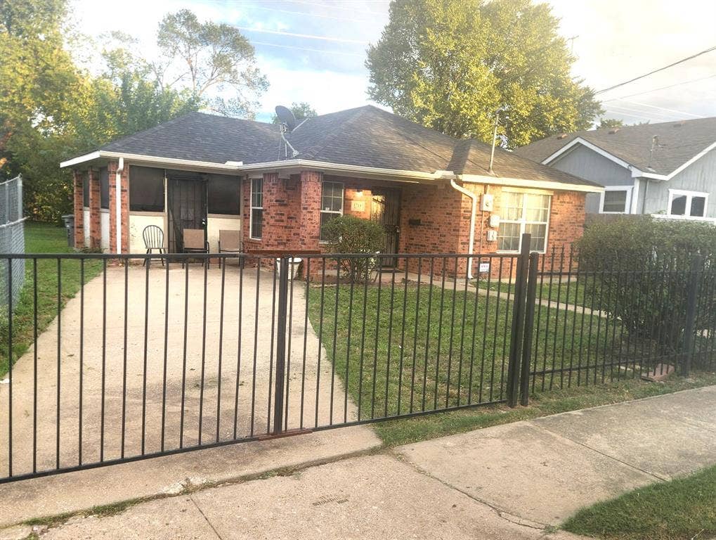 1714 S Denley Drive, Dallas, TX 75216 Front elevation showing gate to driveway