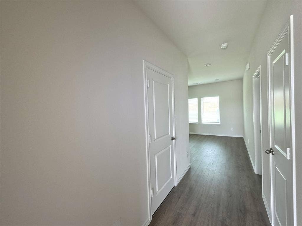 4017 Bronco Drive, Princeton, TX 75407 Hallway featuring wood-finish flooring, white panel interior doors, and recessed ceiling lighting