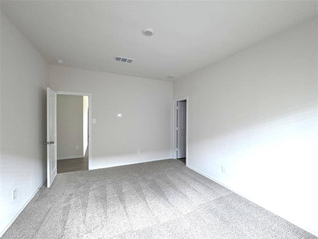 4017 Bronco Drive, Princeton, TX 75407 Neutral-toned interior space featuring light-colored wall paint and wall-to-wall carpeting