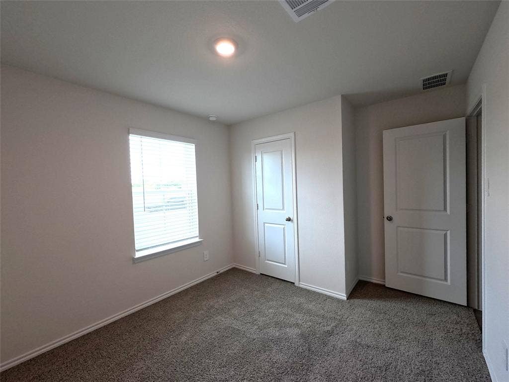 4017 Bronco Drive, Princeton, TX 75407 Neutral-toned room featuring neutral wall-to-wall carpeting, white interior doors, and a recessed ceiling light