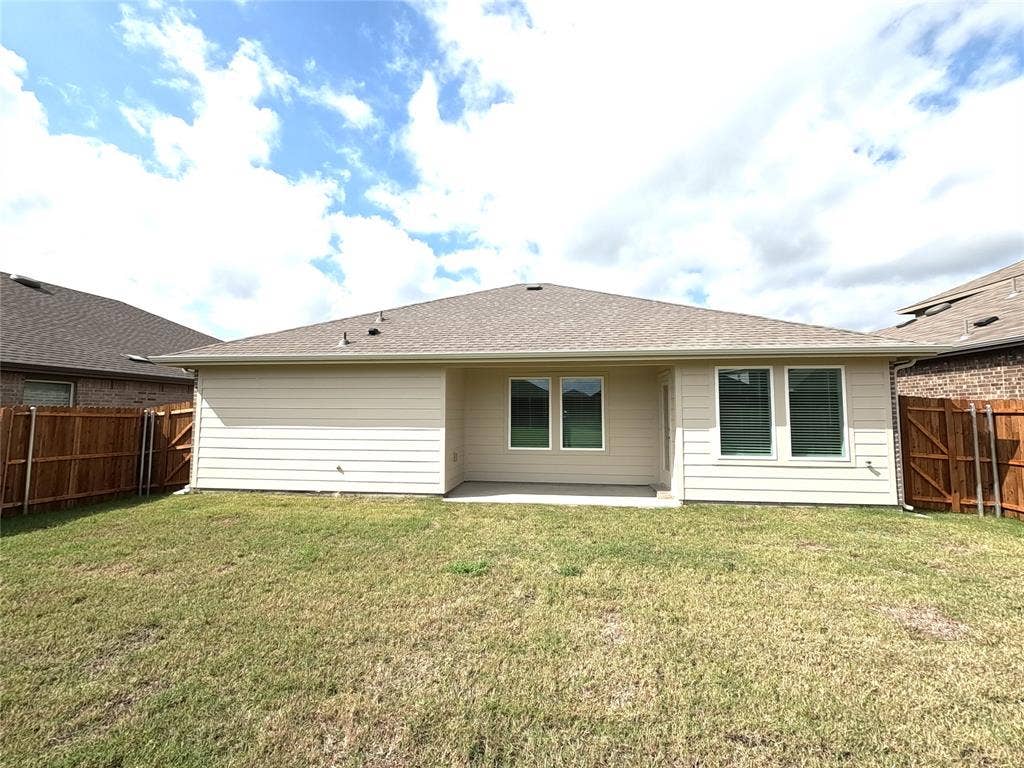 4017 Bronco Drive, Princeton, TX 75407 Exterior rear facade featuring horizontal siding, a covered concrete patio, and a fenced backyard