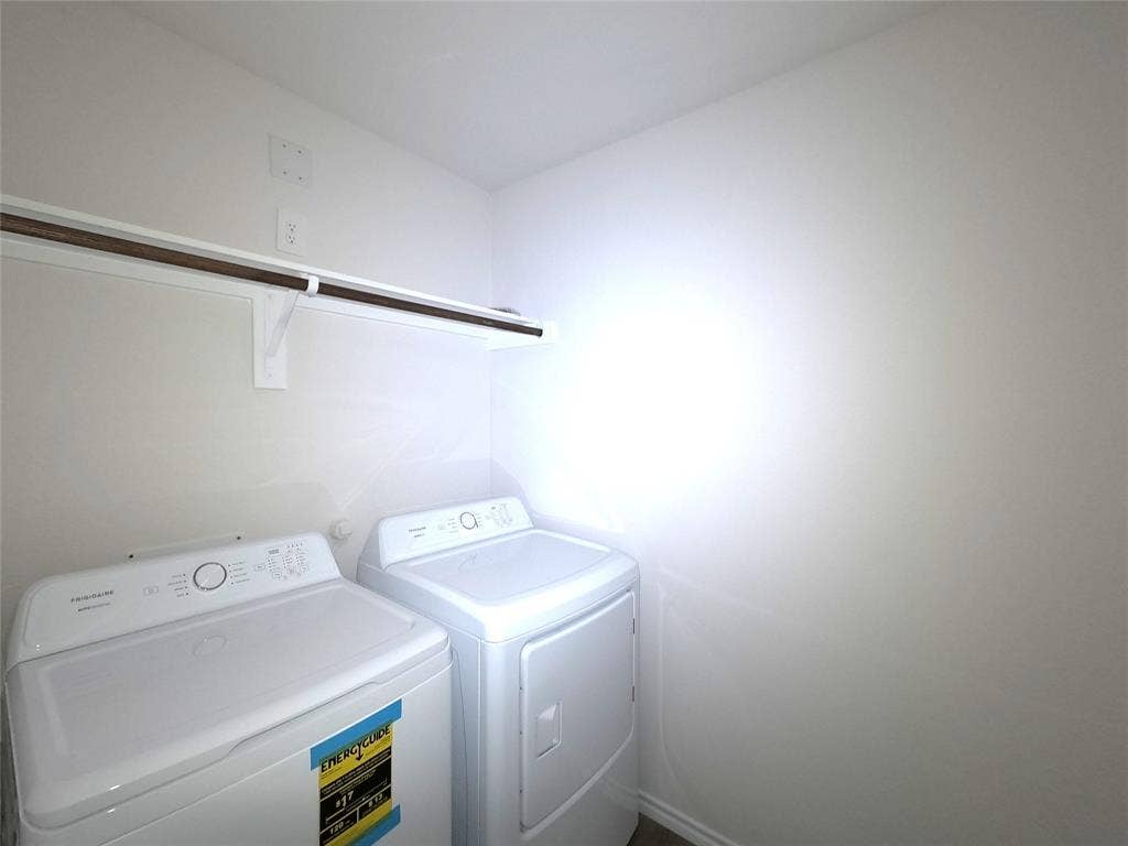 4017 Bronco Drive, Princeton, TX 75407 Dedicated laundry area featuring white appliances and a wall-mounted storage shelf