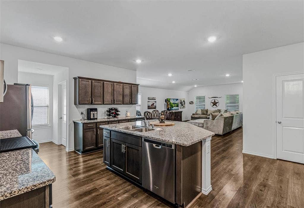 118 Secretariat Lane, Caddo Mills, TX 75135 Kitchen with sink, a kitchen island with sink, dark wood-type flooring, and stainless steel appliances