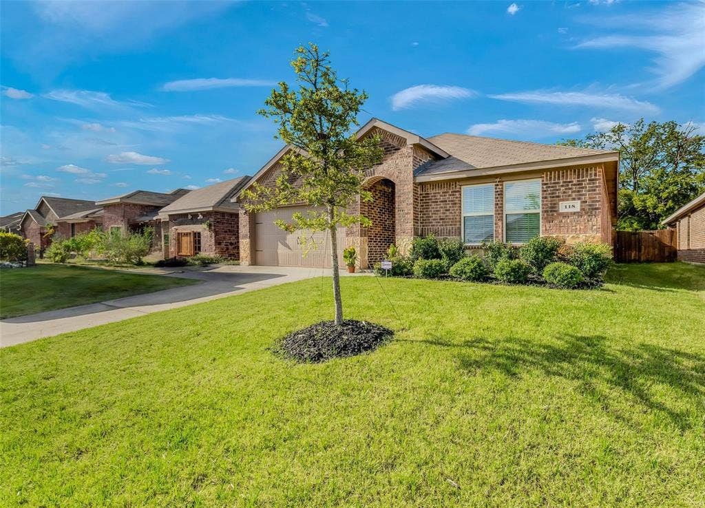 118 Secretariat Lane, Caddo Mills, TX 75135 Ranch-style house featuring a garage and a front lawn