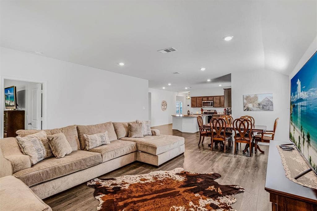 118 Secretariat Lane, Caddo Mills, TX 75135 Living room with vaulted ceiling and light wood-type flooring