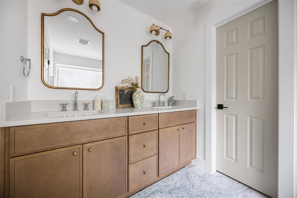 This beautifully renovated, spa-inspired primary bathroom offers a luxurious retreat.