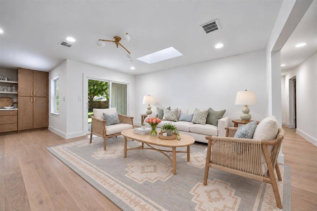 The living space also opens directly to the backyard, extending entertaining outdoors. (This photo has been digitally enhanced.)