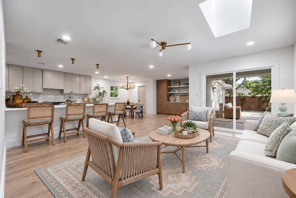 The open-concept living area provides an effortless flow between the home's gathering spaces. (This photo has been digitally enhanced.)