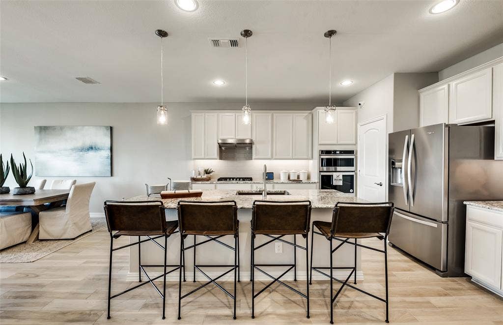 1460 Holmes Street, Celina, TX 75009 *Model Representation - Large island gathering room and dining areas overlooking