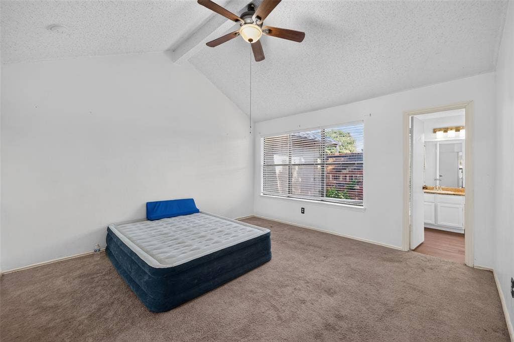 583 Kirkland Drive, Coppell, TX 75019 Vaulted ceiling with a ceiling fan, carpeted flooring, and a large window with horizontal blinds
