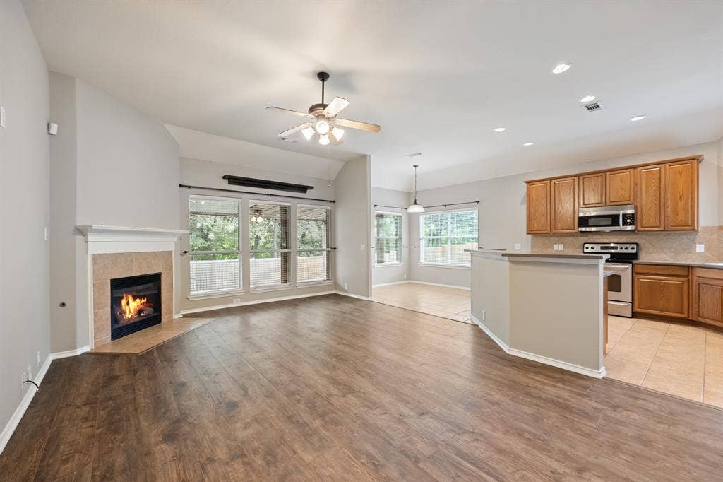 1275 Mission, Rockwall, TX 75087 Large living room with fireplace open to kitchen