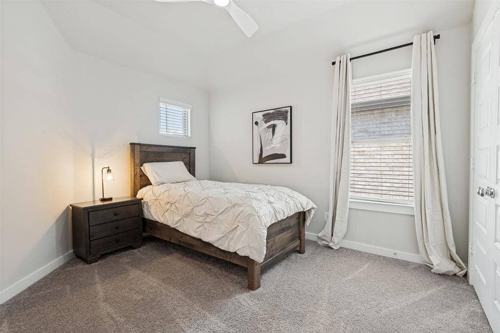 2808 Spring Side Drive, Royse City, TX 75189 Neutral-toned room featuring neutral carpeting, multi-pane window with horizontal blinds, overhead ceiling fan with light, and a multi-panel interior door