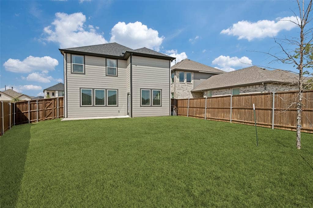 2808 Spring Side Drive, Royse City, TX 75189 Private backyard featuring a manicured lawn, concrete patio, and full-height wood privacy fencing