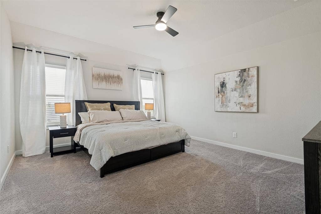 2808 Spring Side Drive, Royse City, TX 75189 Vaulted ceilings, neutral carpeting, dual windows, and an integrated ceiling fan with light fixture