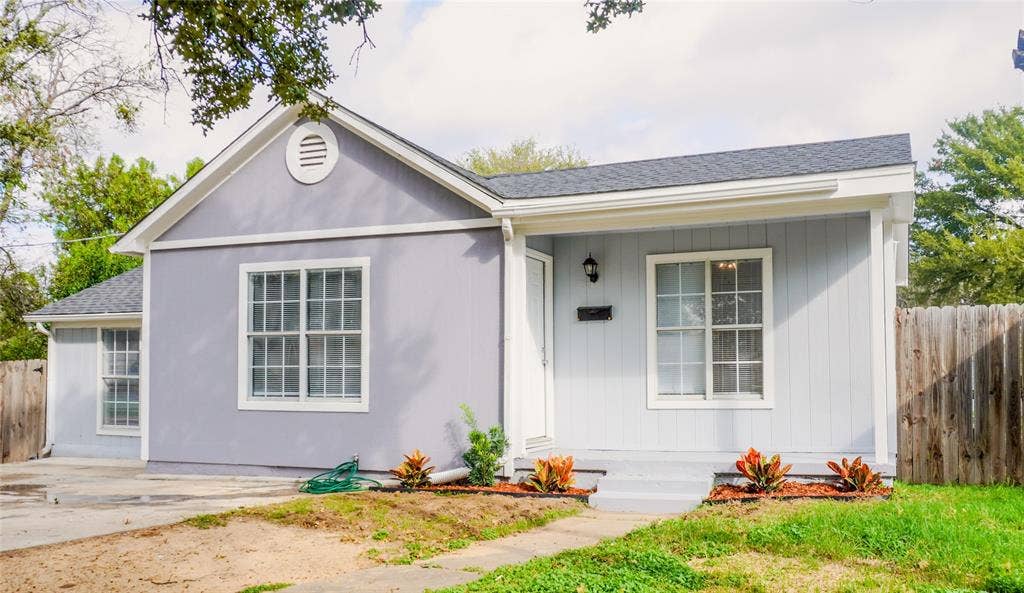 3229 Hardeman Street, Fort Worth, TX 76119 Exterior featuring light-toned vertical siding, a gabled roofline, multi-pane windows, and a covered front entry porch