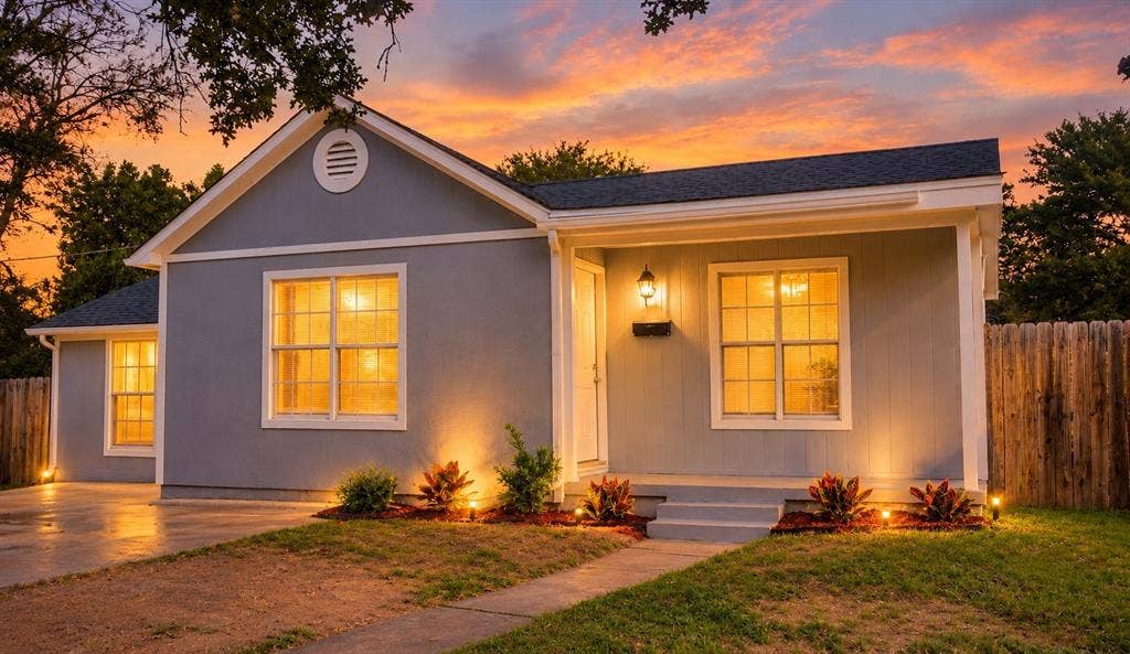 3229 Hardeman Street, Fort Worth, TX 76119 Single-story exterior featuring painted siding, a gabled roof, grid-pattern windows, a concrete driveway, and wood privacy fencing