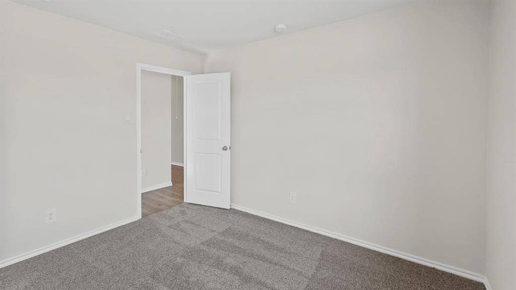 617 Dunham Road, Nevada, TX 75173 Neutral paint palette, gray carpeting, white trim, and a white interior door
