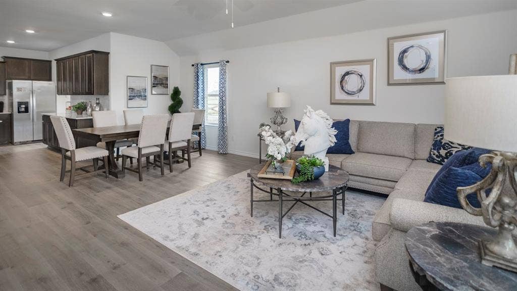 406 Campfield Drive, Caddo Mills, TX 75135 Open-concept living area featuring wood-finish flooring, recessed lighting, and vaulted ceilings