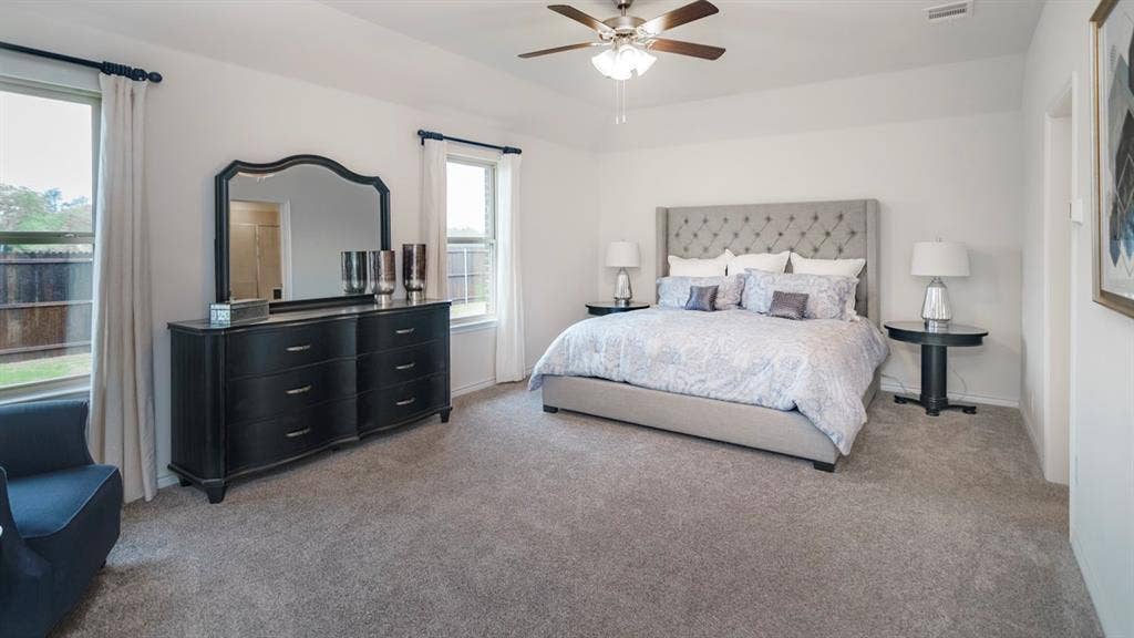 406 Campfield Drive, Caddo Mills, TX 75135 Spacious room with light gray carpeting, neutral wall color, and two windows with white trim