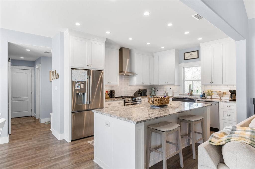 203 Splitrail Drive, Mabank, TX 75143 Kitchen featuring white shaker-style cabinetry, stone countertops, stainless steel appliances, a tiled backsplash, and recessed lighting