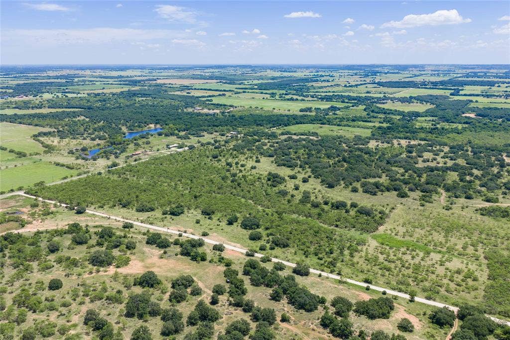 153 Acres FM 583, Rising Star, TX 76471 Three sides of the property have road frontage, this is the gravel road on the back side