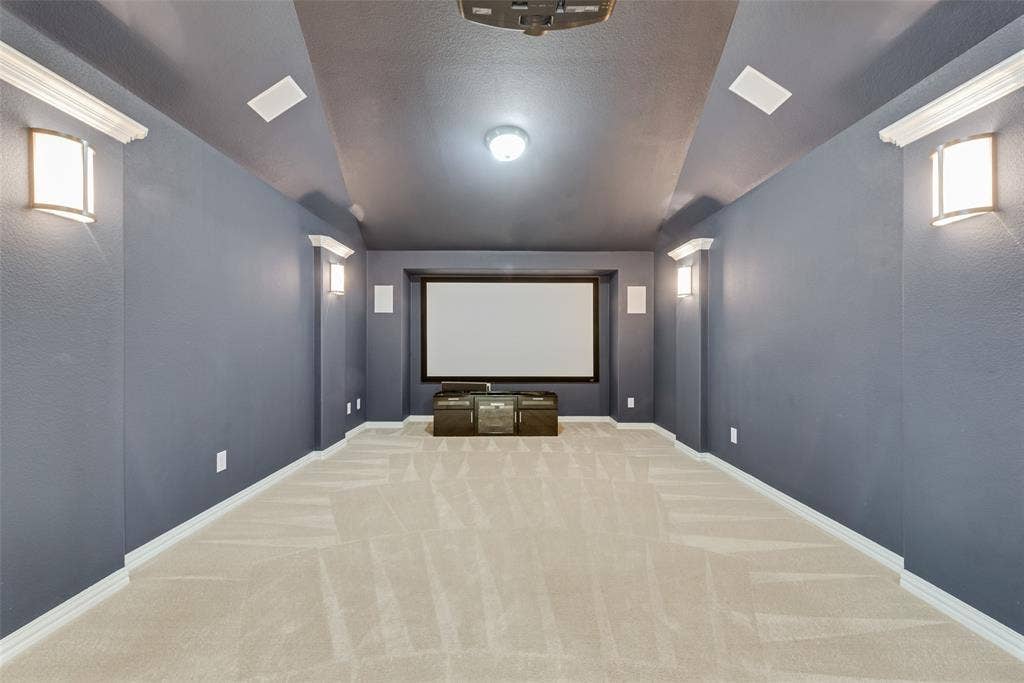 Awesome media room with Epson smart projector, 110" screen, 7.1 surround sound speakers, and theatre lighting.