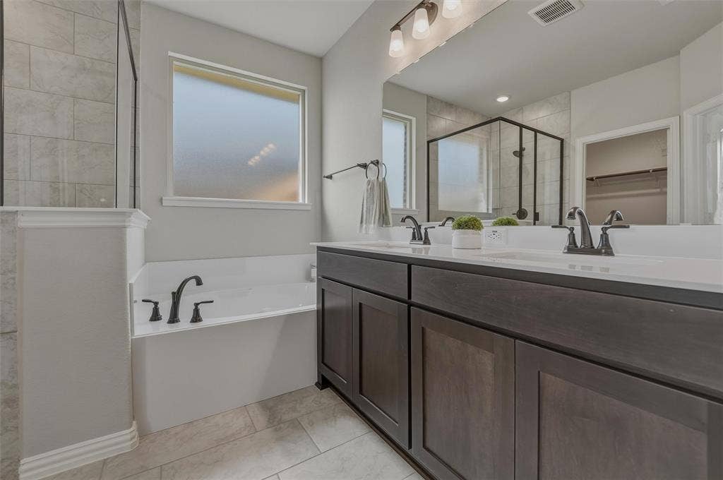 Dual vanity with dark wood-finish cabinetry and white countertops