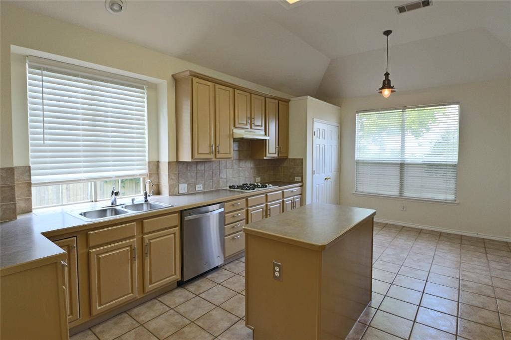 Large and bright kitchen with plenty of cabinets, central island and a large pantry.