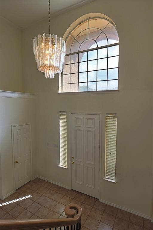 Bright entry with high ceiling and crystal chandelier.