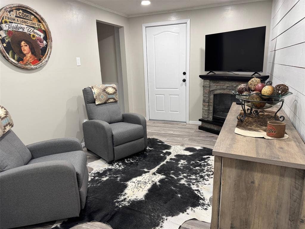 Living area featuring a fireplace, recessed lighting, and light wood-style floors