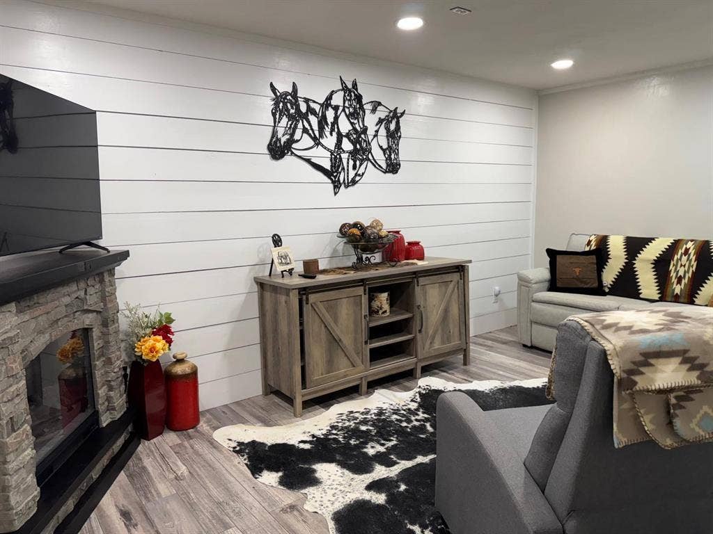 Living area featuring wood finished floors, a fireplace, and recessed lighting