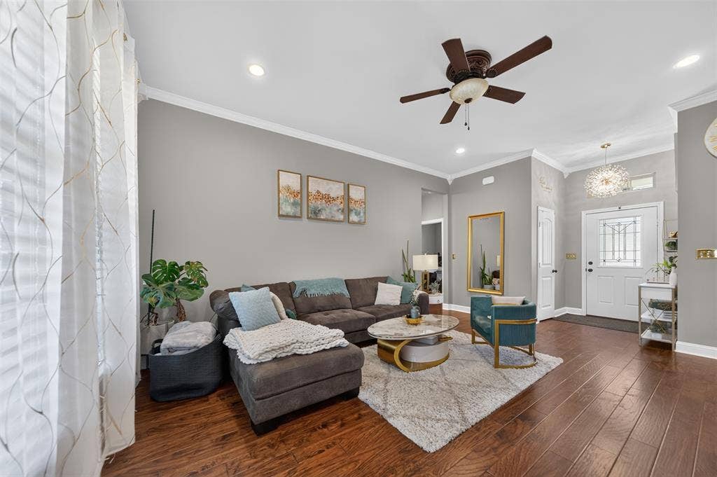 Interior featuring wood-finish flooring, crown molding, recessed lighting, a ceiling fan, and a front entry door with glass paneling