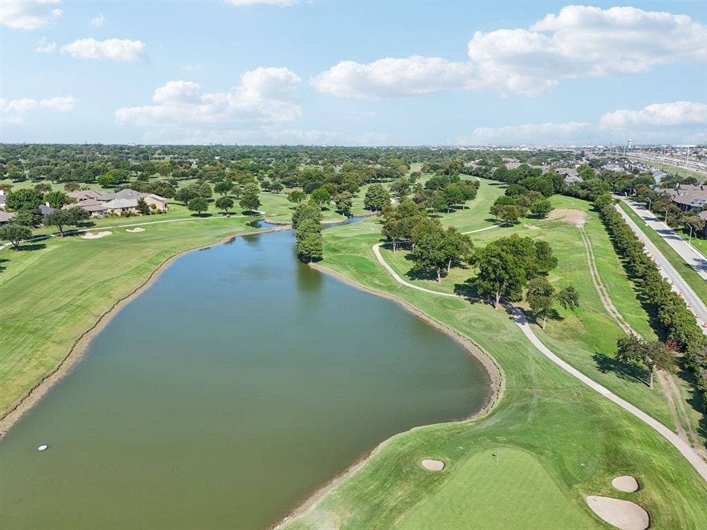 4008 Fairlakes Drive, Dallas, TX 75228 Expansive golf course setting featuring a sizable pond, manicured greens, sand traps, and mature trees
