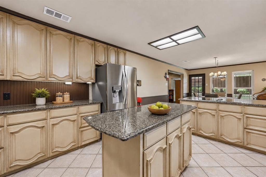4008 Fairlakes Drive, Dallas, TX 75228 Kitchen featuring light-toned cabinetry, granite-finish countertops, stainless steel refrigerator, and tiled flooring