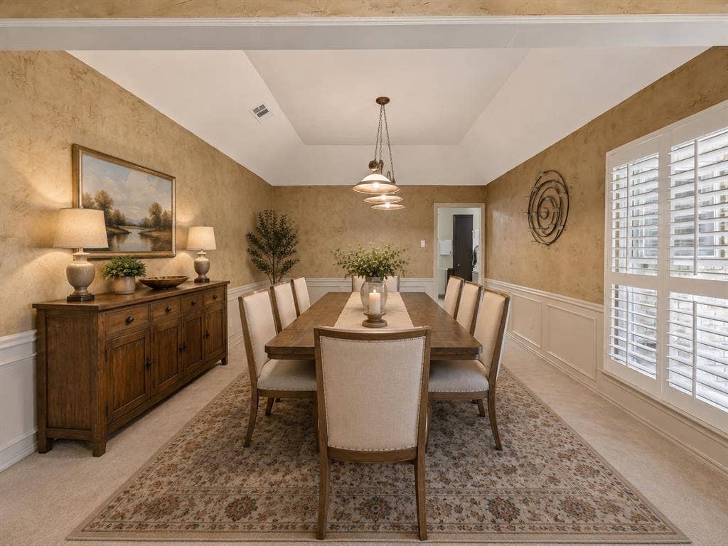 4008 Fairlakes Drive, Dallas, TX 75228 Tray ceiling with a suspended light fixture, wainscoting, textured wall finish, and window with plantation shutters