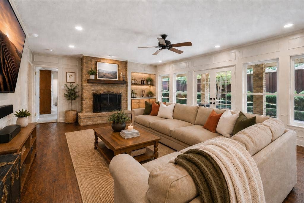 4008 Fairlakes Drive, Dallas, TX 75228 Stone-clad fireplace with a wood-finish mantel, wood-finish flooring, recessed lighting, ceiling fan, and French doors