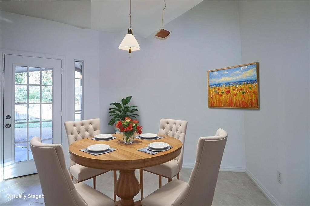 504 Renfro Court, Irving, TX 75063 Vaulted ceiling, neutral wall tones, ceramic tile flooring, multi-pane glass door, and hanging pendant light fixture