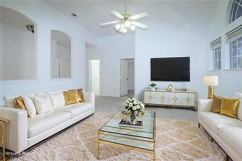504 Renfro Court, Irving, TX 75063 Vaulted ceilings featuring recessed arch niches, neutral carpeting, a central ceiling fan, and multi-pane windows