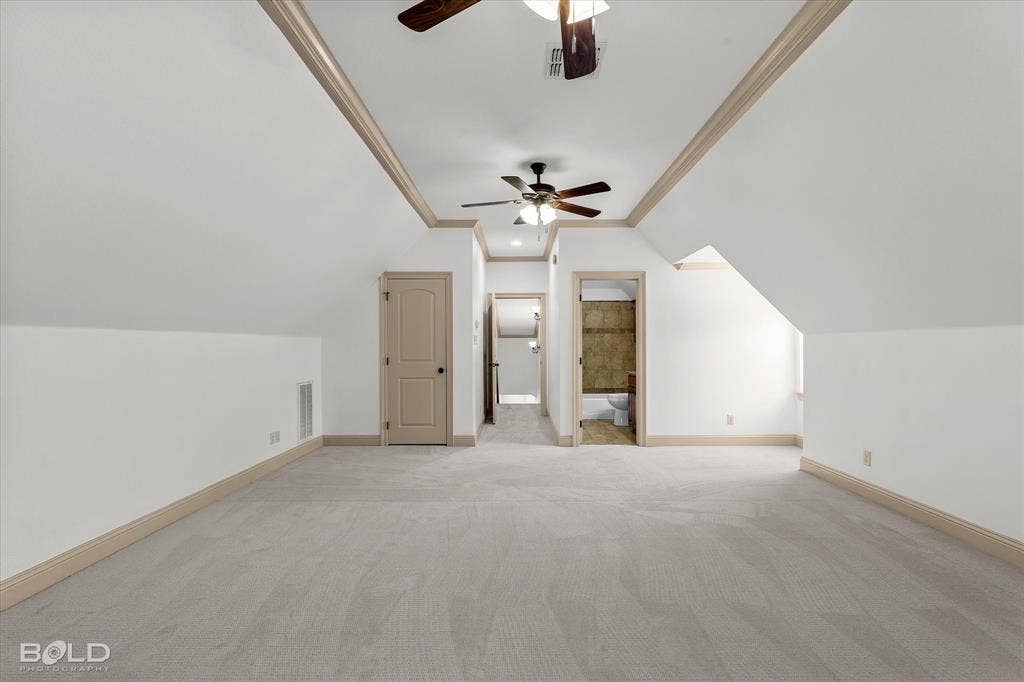 718 Duckwater Landing, Bossier City, LA 71111 Vaulted ceilings featuring tray detailing, neutral carpeting, dual ceiling fans, and interior solid-core doors