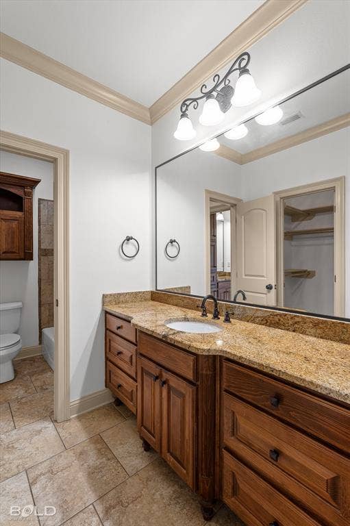 718 Duckwater Landing, Bossier City, LA 71111 Bathroom featuring a wood vanity with stone-finish countertop, undermount sink, oil-rubbed bronze faucet, full-width wall mirror, and ceramic tile flooring