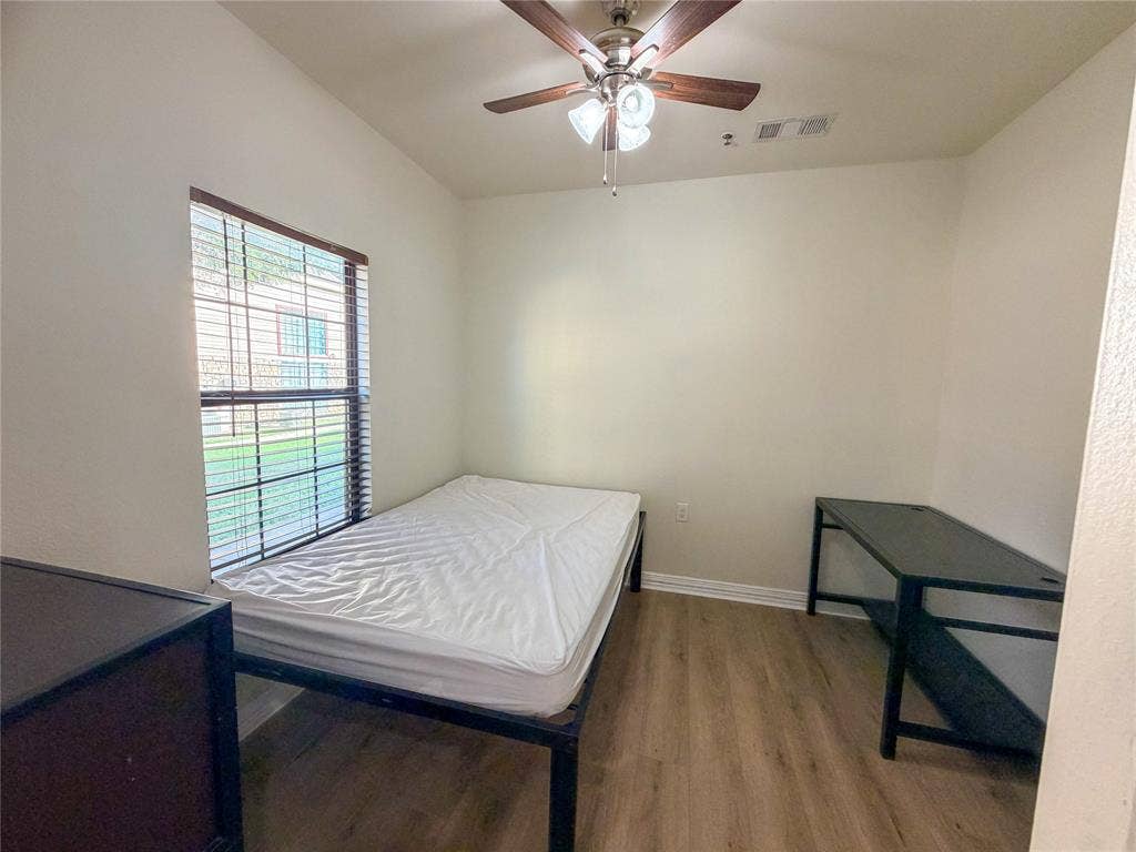 2410 S 2nd Street, #1373, Waco, TX 76706 Wood-finish flooring, ceiling fan with integrated lighting, window with blinds, and neutral wall paint