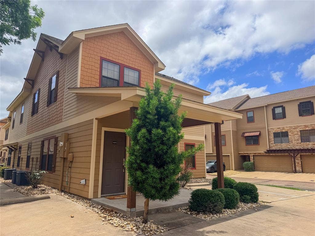 2410 S 2nd Street, #1373, Waco, TX 76706 Multi-level residence featuring a covered entry, horizontal siding, and decorative shingle accents