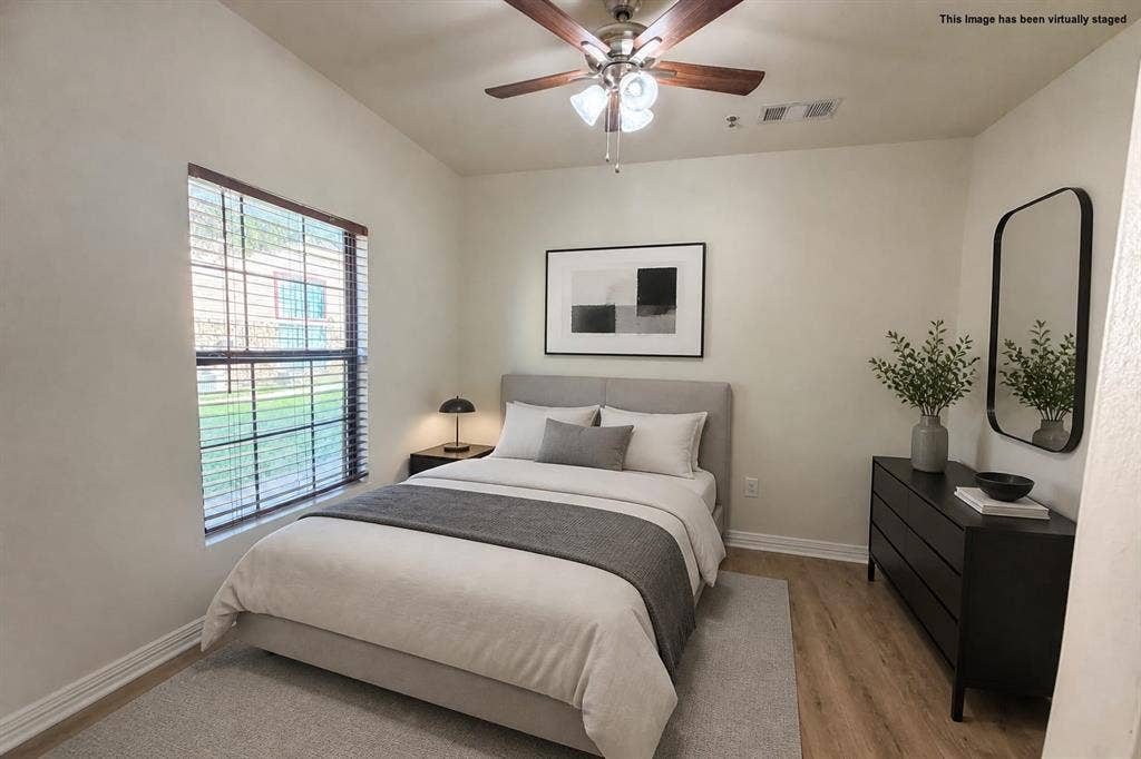 2410 S 2nd Street, #1373, Waco, TX 76706 Bedroom 2 with window with wood-finish blinds, wood-finish ceiling fan with integrated lighting, wood-finish flooring, and light-toned wall paint