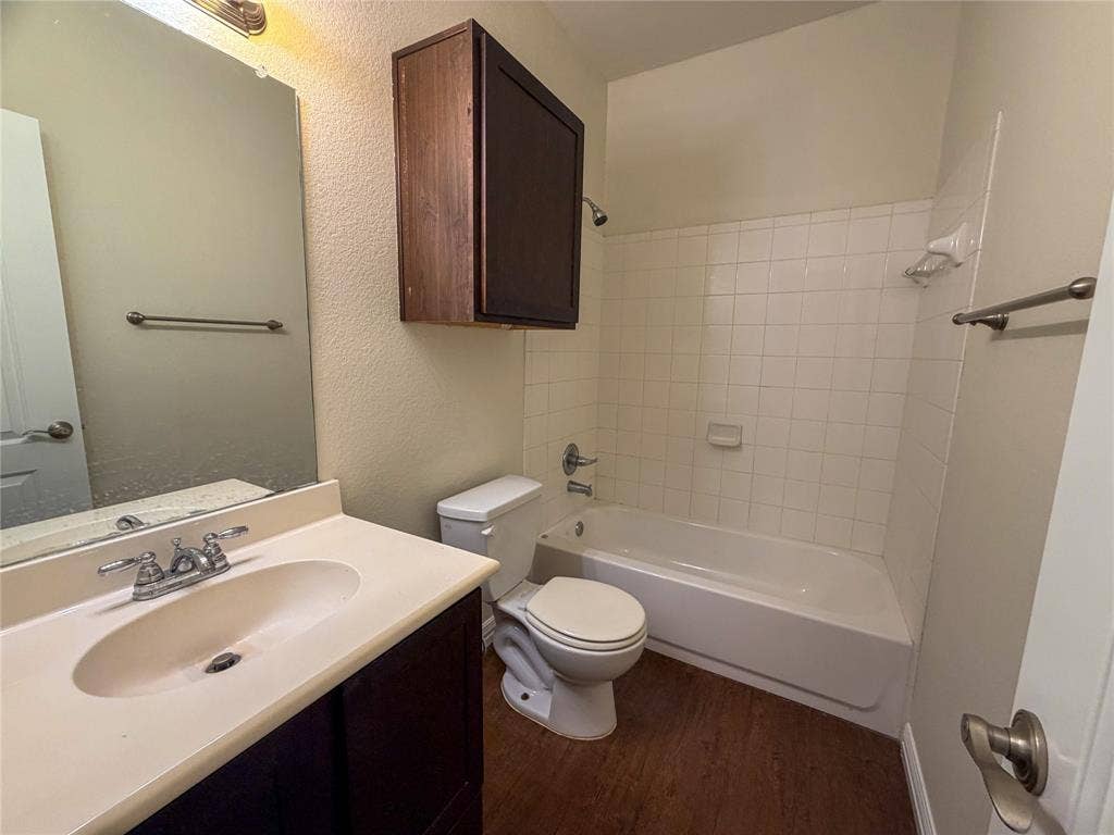 2410 S 2nd Street, #1373, Waco, TX 76706 Bathroom 4: vanity featuring an integrated sink, polished chrome faucet, and dark wood-finish cabinetry
