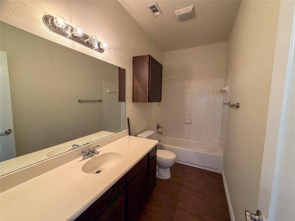 2410 S 2nd Street, #1373, Waco, TX 76706 Bathroom 5: featuring a vanity with a light-toned countertop, integrated sink, and dark wood-finish cabinetry