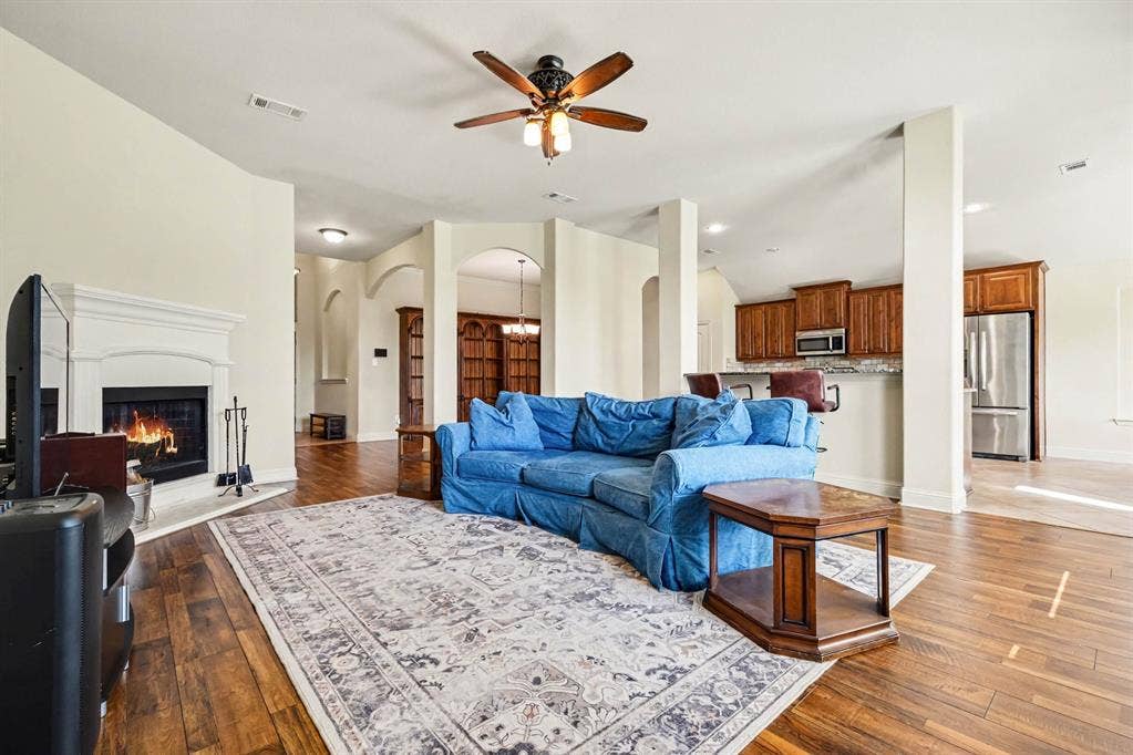 1005 Seminole Lane, Greenville, TX 75402 Open living with a warm fireplace focal point.