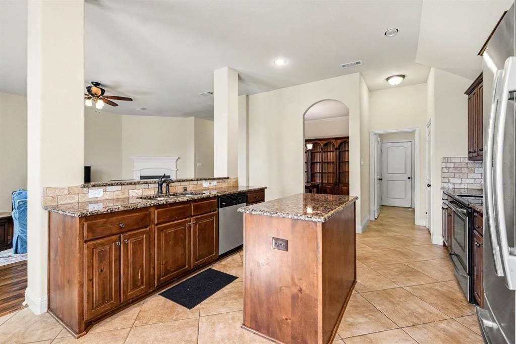 1005 Seminole Lane, Greenville, TX 75402 Granite counters and generous kitchen workspace.
