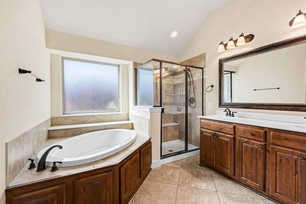 1005 Seminole Lane, Greenville, TX 75402 A primary bath with soaking tub and separate shower.
