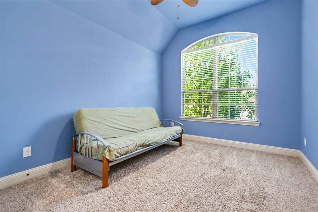 1005 Seminole Lane, Greenville, TX 75402 An airy bedroom with an arched window.